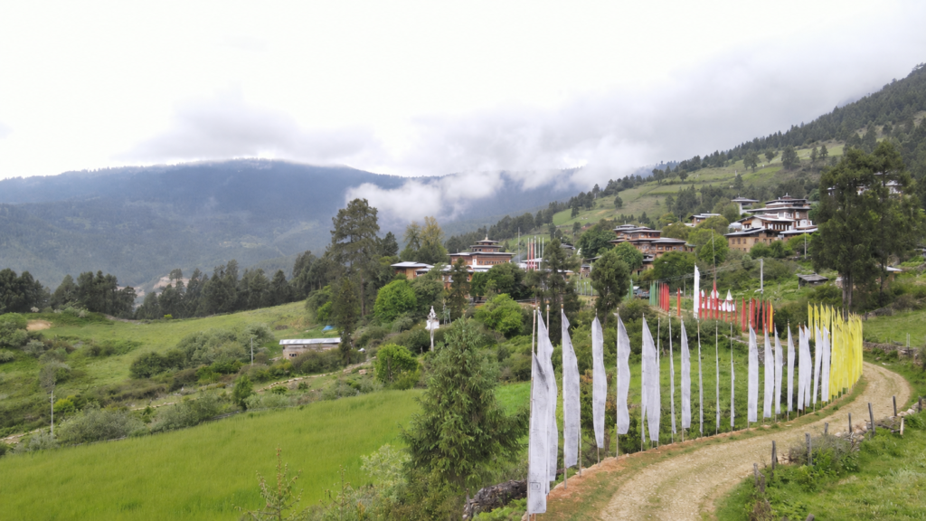 Prayer flags along a path through a village in the Bhutanese hills